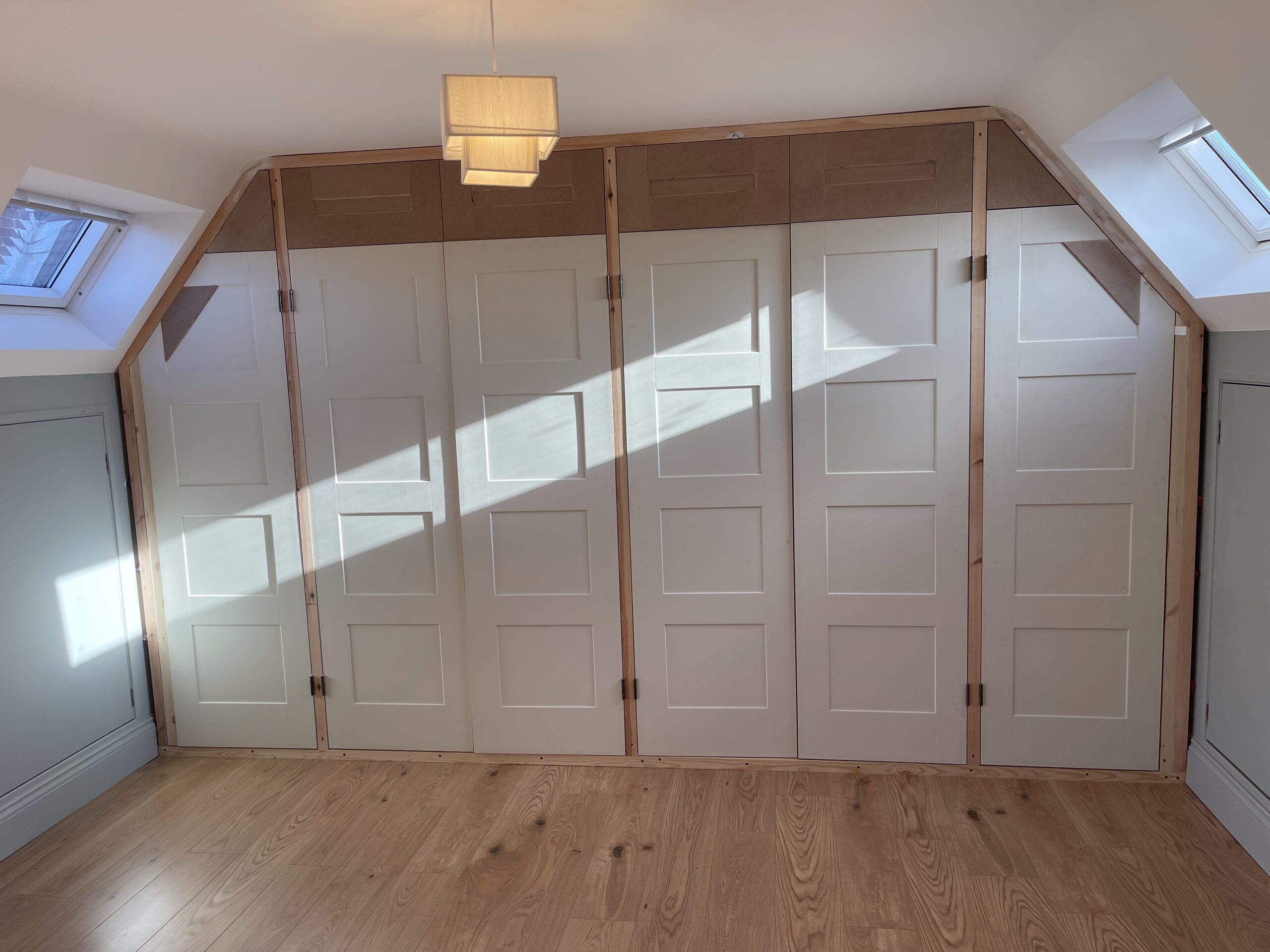 white bedroom wardrobes with panelled door