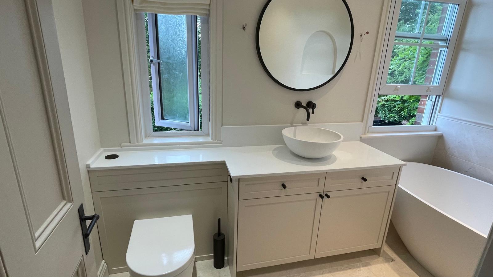cream coloured bathroom vanity with aged brass ironmongery and shaker style doors